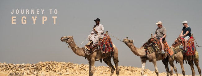Three camel riders crossing rocky ground beneath the title Journey to Egypt.