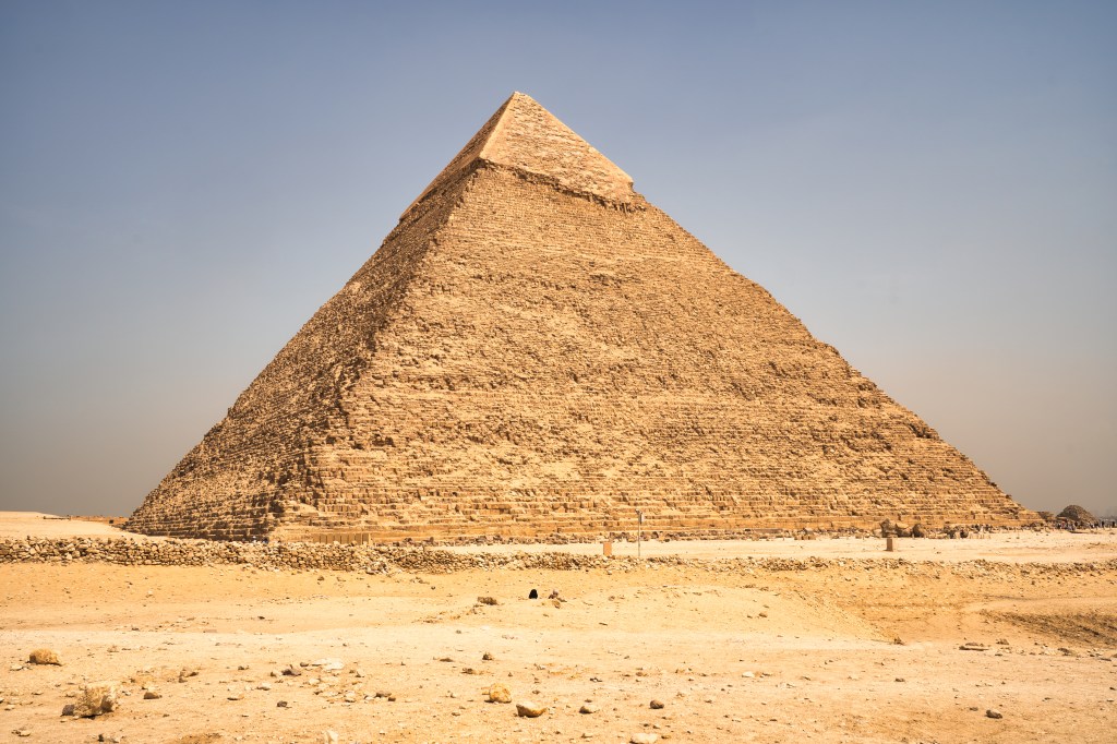 Sunlit pyramid with surviving smooth casing near its summit.