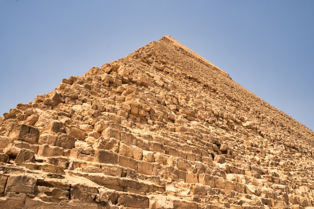 Rough stone blocks rising towards the summit of a pyramid.