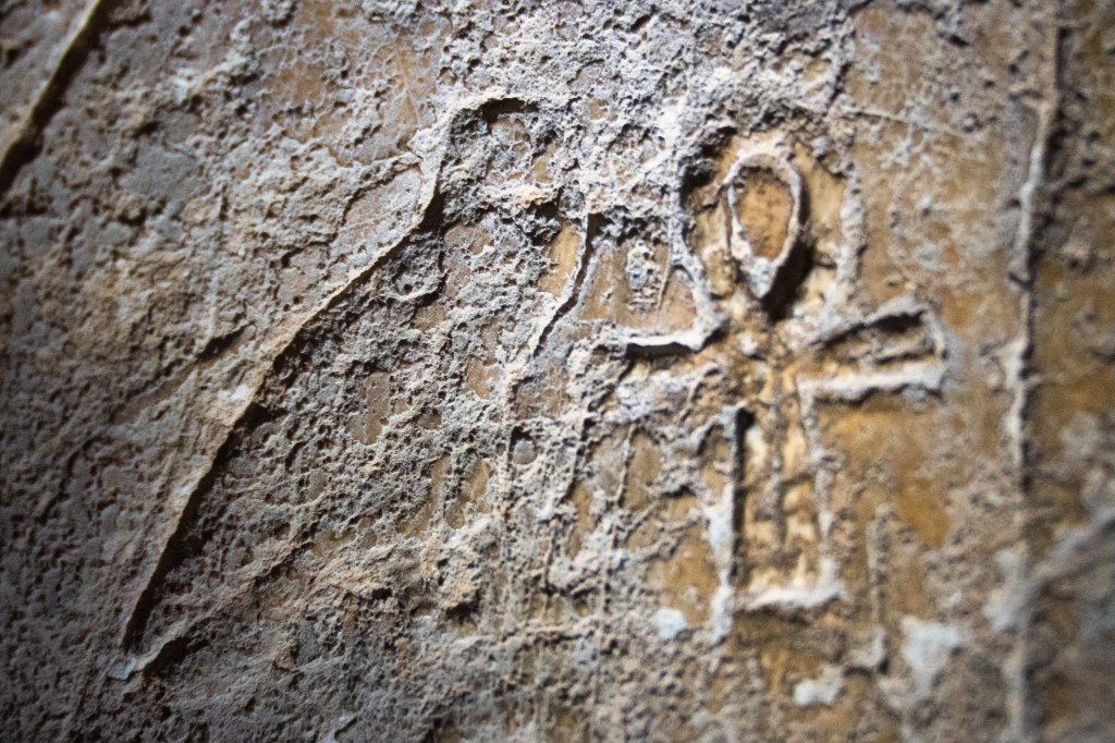 Weathered hieroglyphs carved into stone.