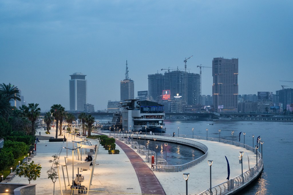 Lights along a Nile promenade during the blue hour.