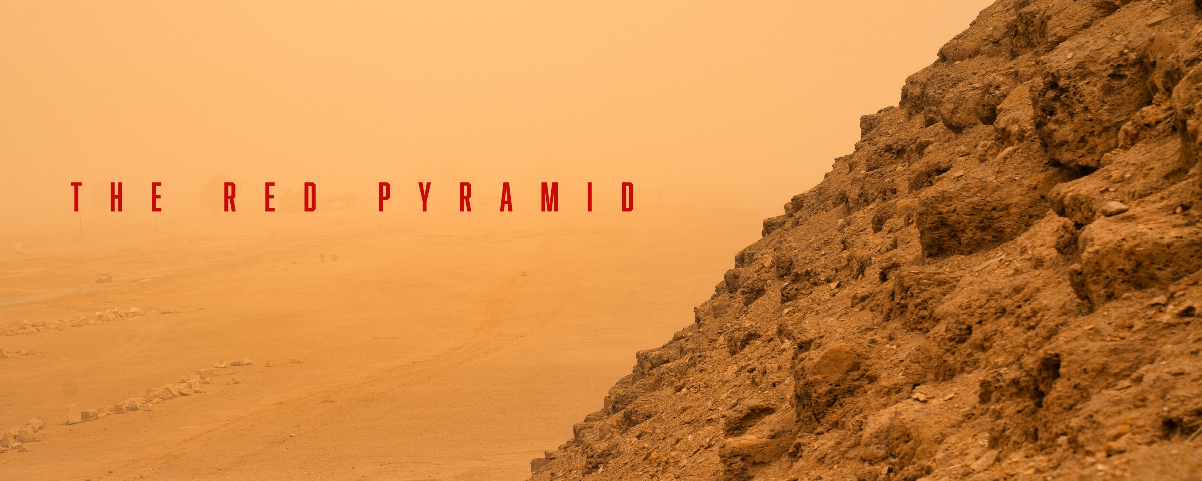 Weathered pyramid stones beside a hazy desert landscape and the title The Red Pyramid.